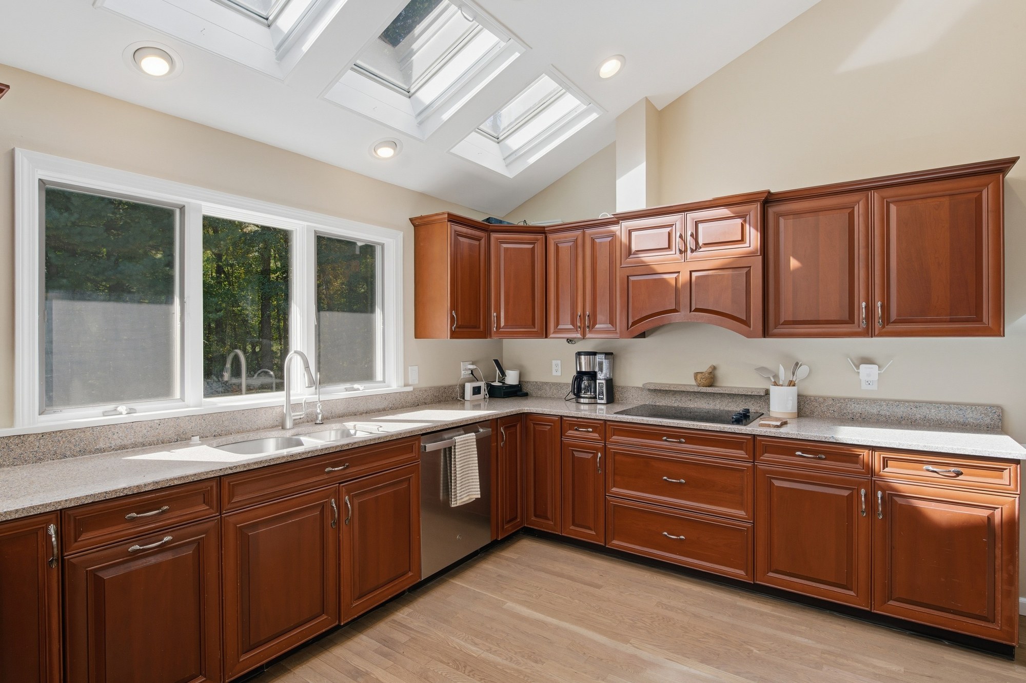 Kitchen with wooden cabinets and garden-facing windows at Fox Hill Road