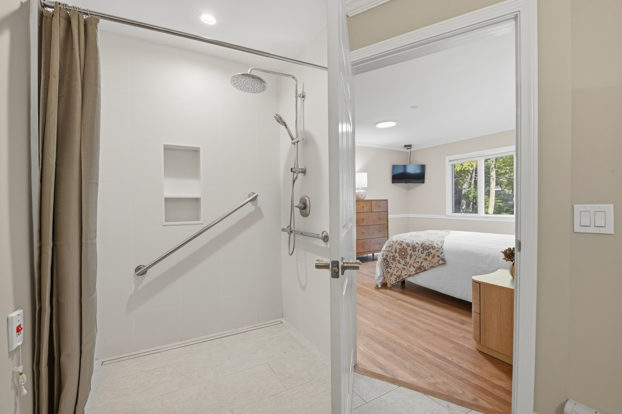 Accessible bathroom with grab bars and a roll-in shower at Fox Hill Road