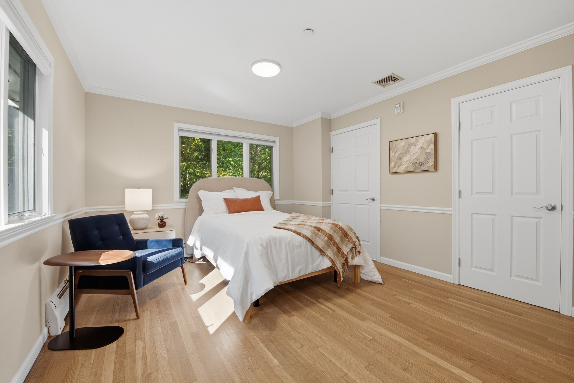 Bedroom with bedside seating and wood floors at Fox Hill Road